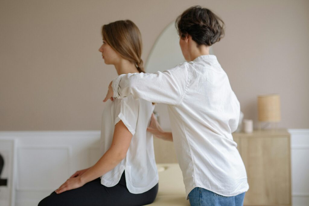 A therapist provides a relaxing shoulder massage in a modern spa environment.